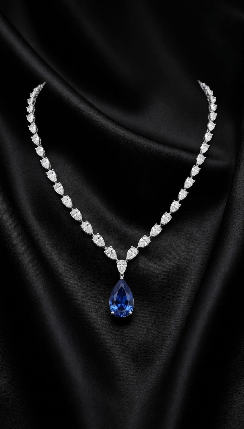 14 carat lab grown sapphire pear shaped center with 22 carats total lab grown diamond necklace in 14k white gold 